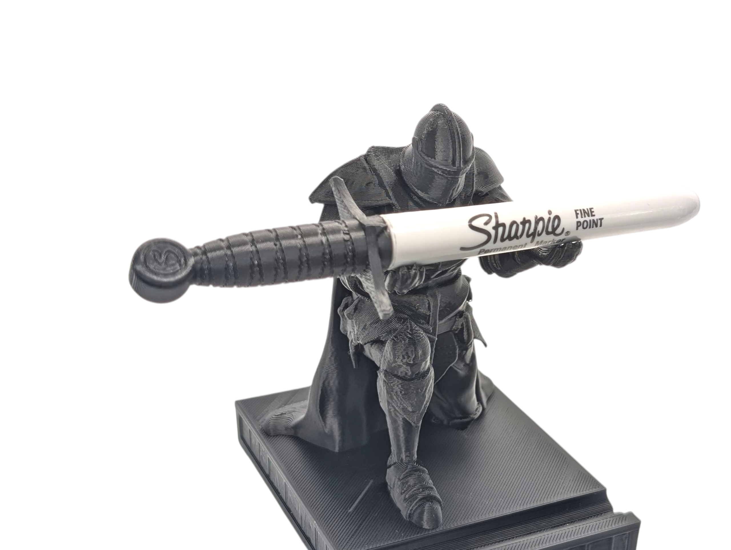 Figurine of a character holding a Sharpie marker on a white background